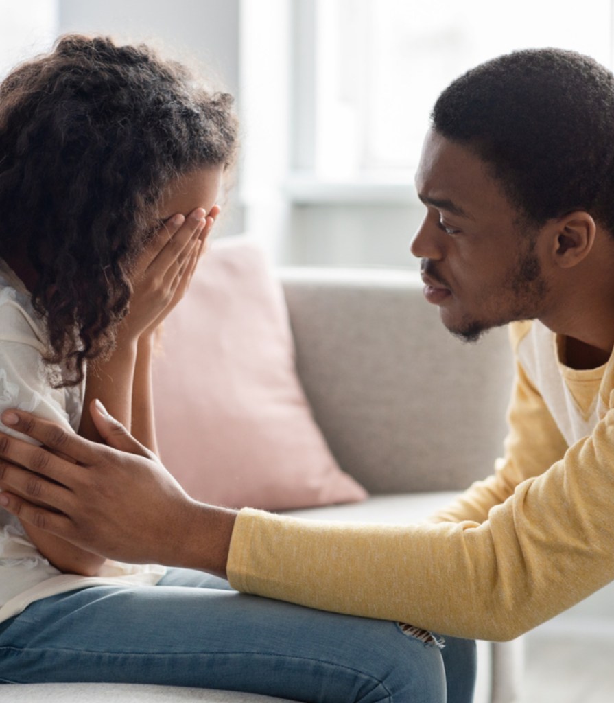 An adult gently comforting a child, offering support and care during a moment of distress.