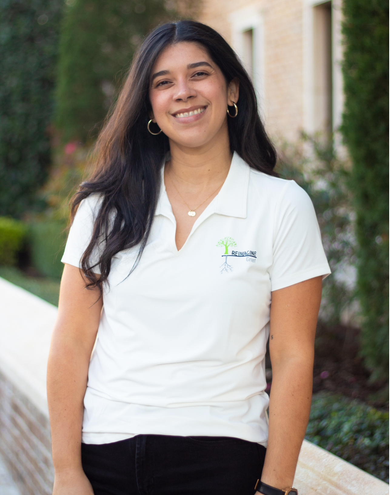 Zuliann, a staff member at Reimagine Grief, smiling and ready to assist children and families.