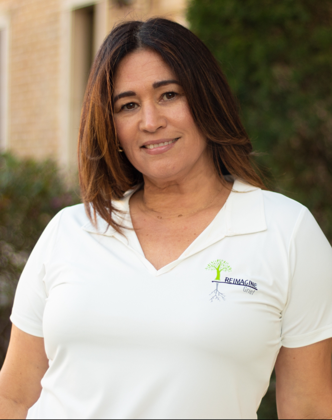 Christina, a staff member at Reimagine Grief, smiling and ready to assist children and families.