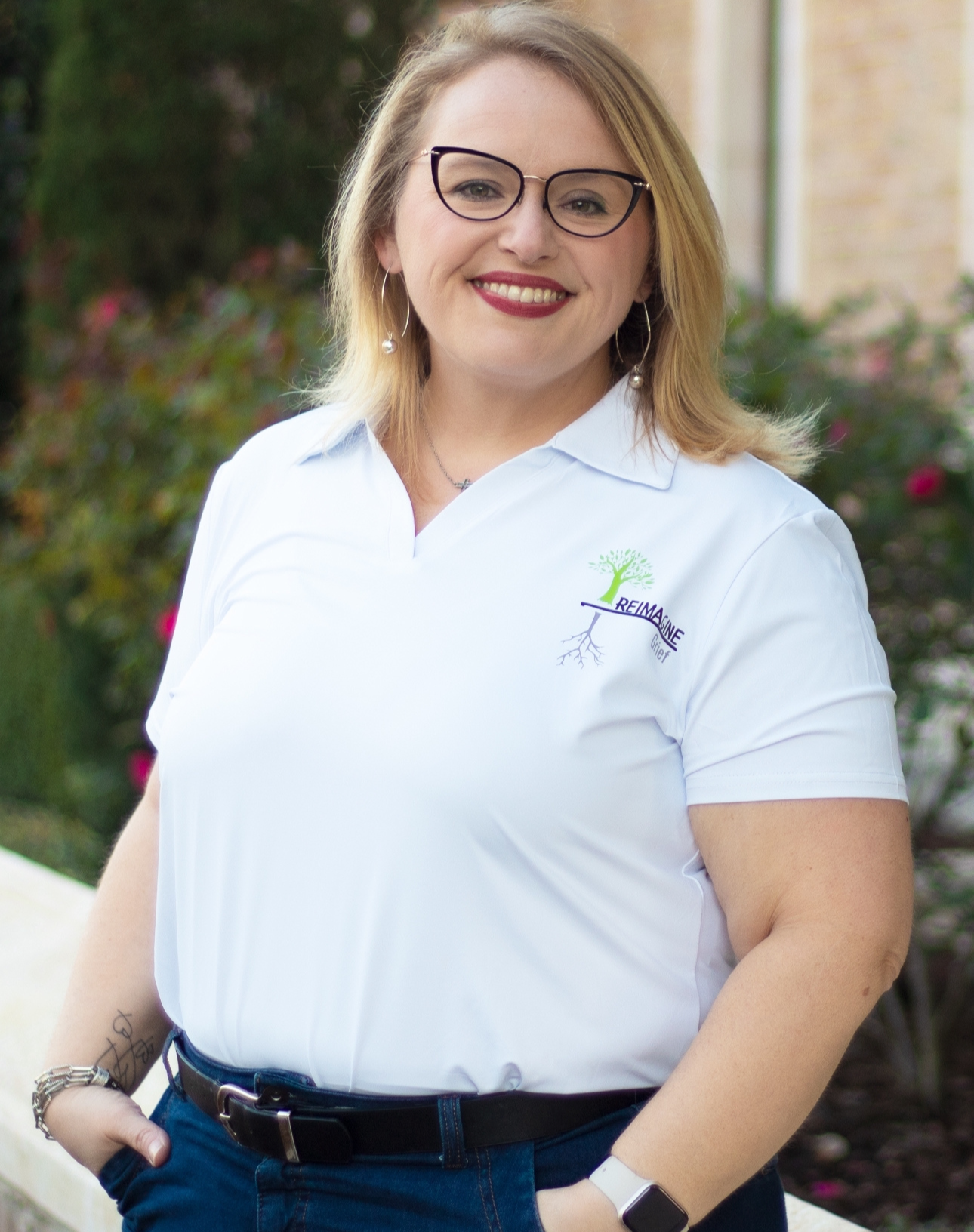 Summer, a staff member at Reimagine Grief, smiling and ready to assist children and families.